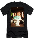 Chocolate Cake with Green Icing on a Faux Wood Cake Stand on a Table in a Barbecue Restaurant Rannells Greg T-Shirt