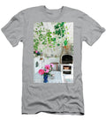 Vase of Pink Peonies on Garden Table in White Wooden Veranda with Fireplace Annette Nordstrom T-Shirt
